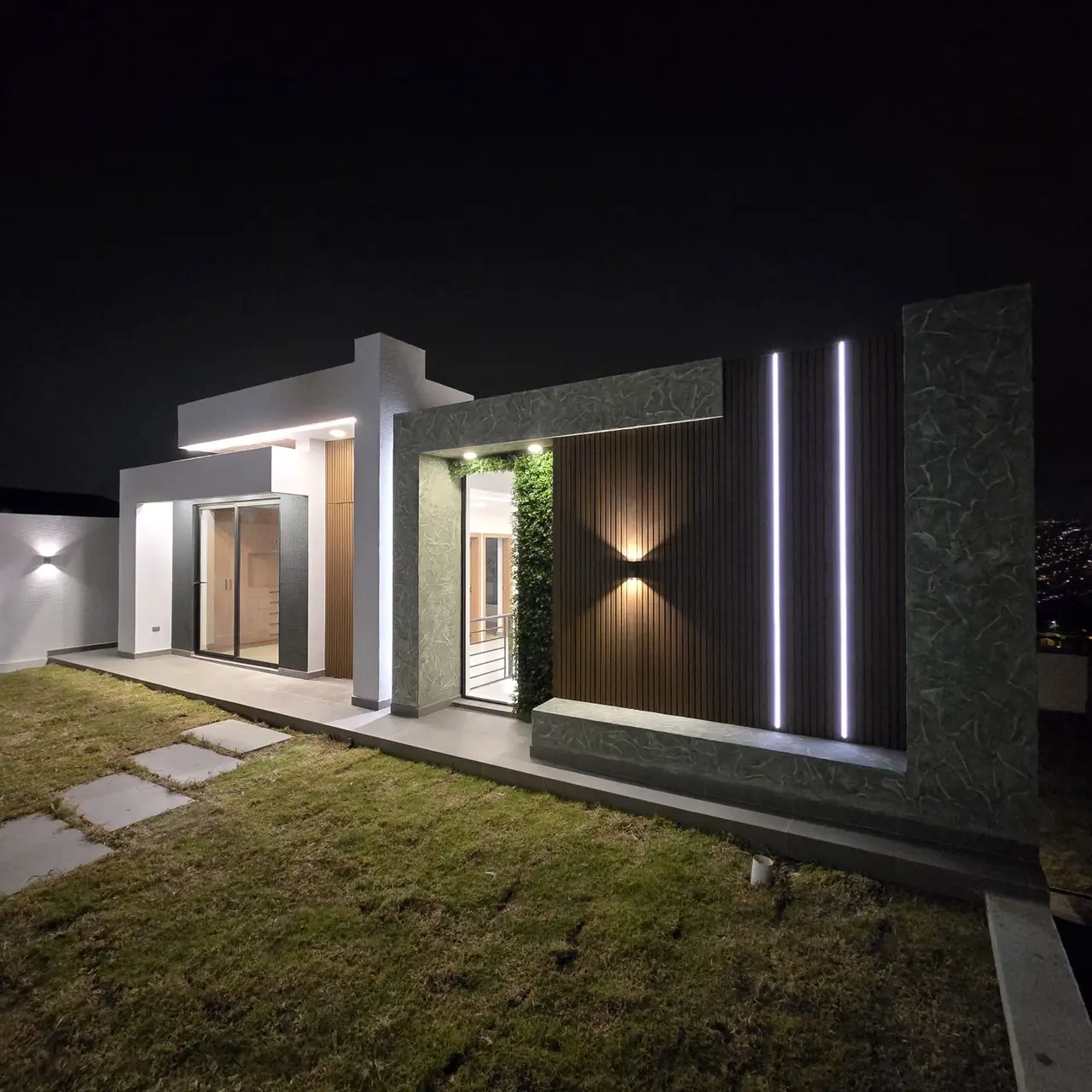 Casa con iluminación nocturna construida por PIVOT Constructores en Quito